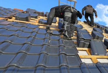 Roofer tiling a new roof