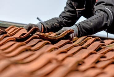 roofing expert working on damaged residential roof